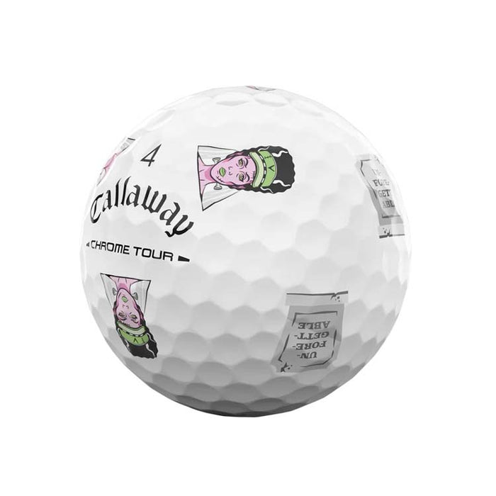 A white Callaway Chrome Tour golf ball with black text and cartoon character graphics, isolated on a white background.