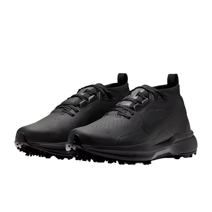A pair of black Nike golf shoes with textured synthetic uppers, black laces, and black spiked outsoles, shown against a plain white background.