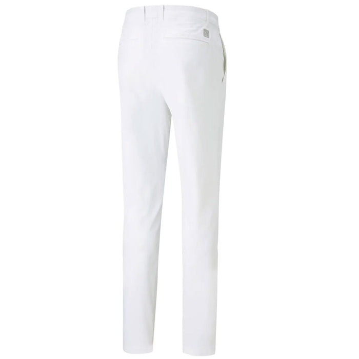 White puma men's slim-fit trousers shown from the back, featuring a clean waistband, belt loops, and a small metallic brand plaque on the upper right side.